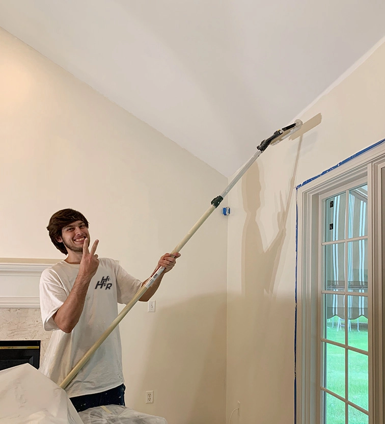 Harry Mason painting a wall